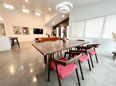 a dining room with a large wooden table and chairs at The Butterfly House - with sauna in Sanford