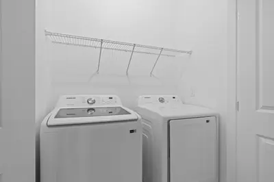 a kitchen with a stove and a washer and dryer at Cozy Master Room with Private Bath in Kissimmee