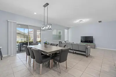 a dining room and living room with a table and chairs at Cozy Master Room with Private Bath in Kissimmee