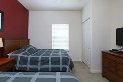 a bedroom with a bed and a flat screen tv at Your VIP Home in Orlando Disney 25106 in Kissimmee