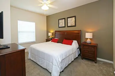 a bedroom with a bed and a ceiling fan at Your VIP Home in Orlando Disney 25106 in Kissimmee