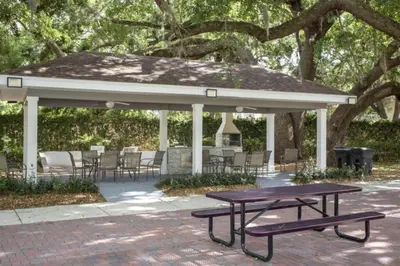 a picnic table under a pavilion with tables and chairs at Your VIP Home in Orlando Disney 25106 in Kissimmee