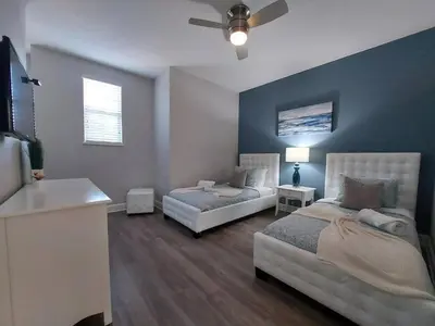 a bedroom with two beds and a ceiling fan at Serenity Close to Disney Orlando in Orlando