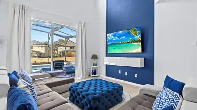 a living room with a couch and a large window at Ever After Adventure Villa - Themed Rooms, Game Room, Private Pool Near Disney in Kissimmee
