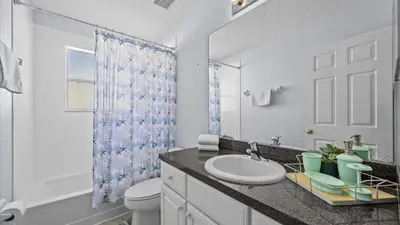 a bathroom with a sink and a toilet and a shower at Ever After Adventure Villa - Themed Rooms, Game Room, Private Pool Near Disney in Kissimmee