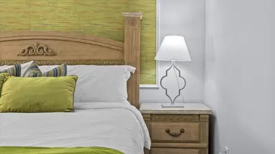 a bedroom with a bed and a lamp on a nightstand at Ever After Adventure Villa - Themed Rooms, Game Room, Private Pool Near Disney in Kissimmee