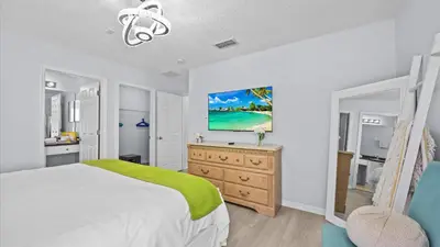 a bedroom with a bed and a tv on a dresser at Ever After Adventure Villa - Themed Rooms, Game Room, Private Pool Near Disney in Kissimmee