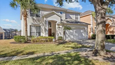a house with palm trees in front of it at Ever After Adventure Villa - Themed Rooms, Game Room, Private Pool Near Disney in Kissimmee