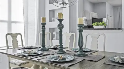 a dining room table with plates and candles on it at Ever After Adventure Villa - Themed Rooms, Game Room, Private Pool Near Disney in Kissimmee