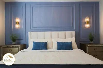 a bedroom with blue walls and a large bed with blue pillows at NEW Renewed 3BD Modern 10 Min to Disney in Kissimmee