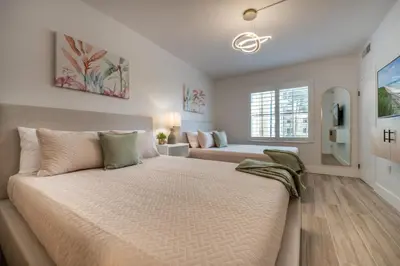 a bedroom with a large bed and a window at Pool view apartment near Epic Universe and Universal Studios in Orlando