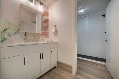 a bathroom with a sink and a mirror at Pool view apartment near Epic Universe and Universal Studios in Orlando