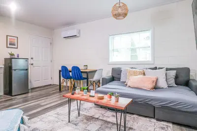 a living room with a couch and a table at NEW Designed Apt 2023 NrUCF PETSOk PrivateEntry in Orlando