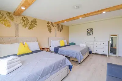 a bedroom with two beds and a dresser at BRANDNEW 2023 LAKEFRONT APT in Kissimmee