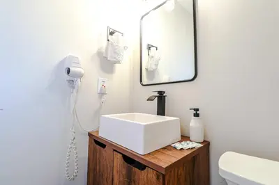 a bathroom with a white sink and a mirror at NEW5 APT NrUCF PETSOK PRIVATE patioENTRY LAUNDRY in Orlando