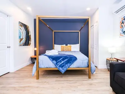 a bedroom with a canopy bed with blue walls at NEW5 APT NrUCF PETSOK PRIVATE patioENTRY LAUNDRY in Orlando