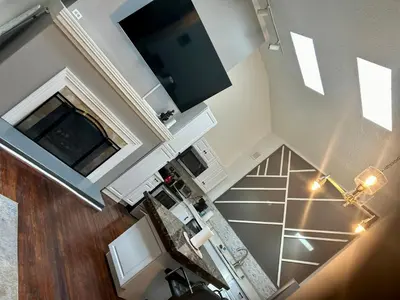 an overhead view of a kitchen with a staircase in a house at Renovated Peaceful Luxury Walk to Mall Park Publix in Orlando