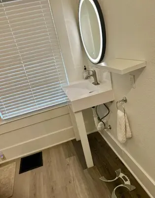 a bathroom with a sink and a mirror at Renovated Peaceful Luxury Walk to Mall Park Publix in Orlando