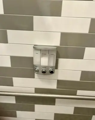 a wall with a paper towel dispenser on it at Renovated Peaceful Luxury Walk to Mall Park Publix in Orlando