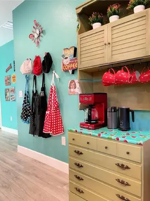 a bedroom with a dresser and a shelf with bags at The Sanford Bandstand in Sanford
