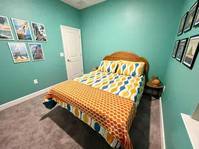 a bedroom with a bed in a room with blue walls at The Sanford Bandstand in Sanford