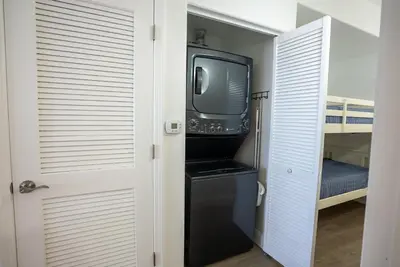 a small black refrigerator and a tv in a room at Orlando 4th Floor - 5 min Disney in Orlando