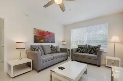 a living room with two couches and a table at Wonderful Life at Windsor Hills in Orlando