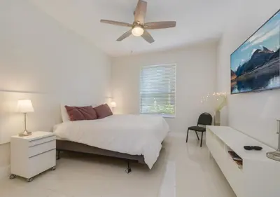 a white bedroom with a bed and a ceiling fan at Wonderful Life at Windsor Hills in Orlando