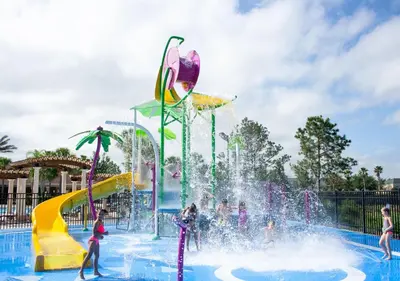 a water park with people playing in a fountain at Wonderful Life at Windsor Hills in Orlando