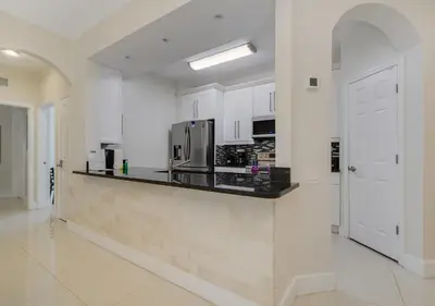 a kitchen with white cabinets and a counter top at Wonderful Life at Windsor Hills in Orlando
