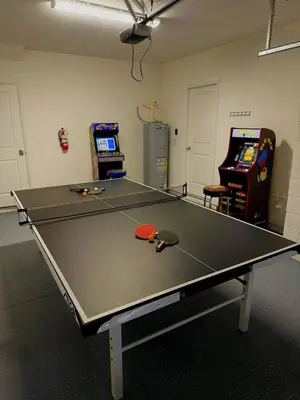 a ping pong table with a pair of scissors on it at Themed Home Near Disney with Pool in Kissimmee