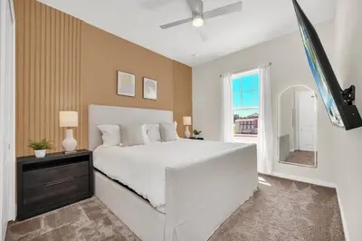 a bedroom with a bed and a tv in it at Enchanted Home Near Disney in Orlando