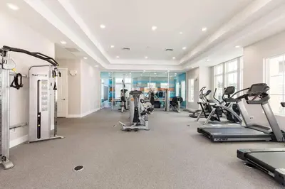 a gym with treadmills and cardio equipment in a building at Enchanted Home Near Disney in Orlando