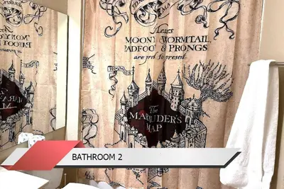 a bathroom with a shower curtain of a castle at Harry Potter-Themed, Lake View, Spacious Condo Near Universal with Extra Amenities in Orlando
