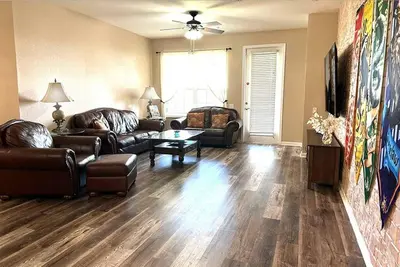 a living room with leather couches and a table at Harry Potter-Themed, Lake View, Spacious Condo Near Universal with Extra Amenities in Orlando