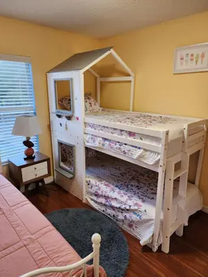 a bedroom with two bunk beds and a mirror at Island Abode -near Disney in Kissimmee