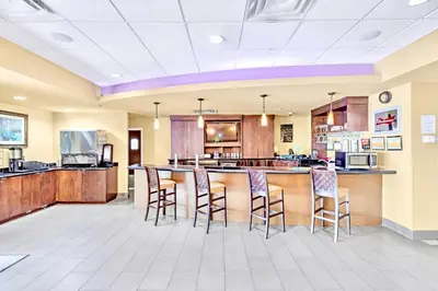 a large kitchen with a bar with stools at Contemporary Apartment with Pool Hot Tub - Close to Universal Studios in Orlando