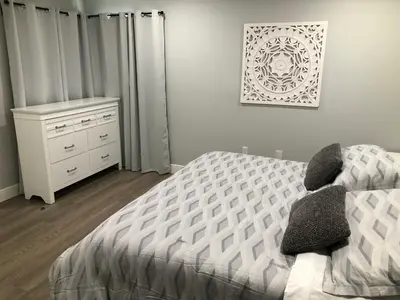 a bedroom with a bed and a dresser in it at Cozy apartment near Disney with 3 bedrooms 58 in Kissimmee