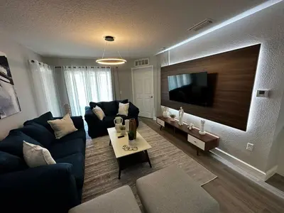 a living room with a blue couch and a tv at Cozy apartment near Disney with 3 bedrooms 58 in Kissimmee