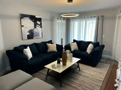 a living room with a blue couch and a table at Cozy apartment near Disney with 3 bedrooms 58 in Kissimmee