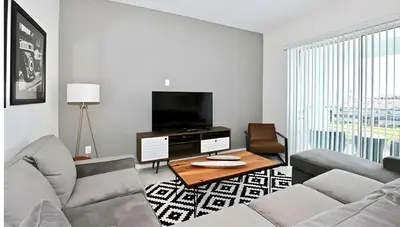 a living room with a couch and a table and a tv at 3BE&2BA Apartment at Storey Lake Resort 59 in Kissimmee