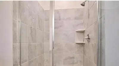 a shower with a glass door in a bathroom at 3BE&2BA Apartment at Storey Lake Resort 59 in Kissimmee