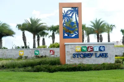 a sign for a store with palm trees in the background at 3BE&2BA Apartment at Storey Lake Resort 59 in Kissimmee