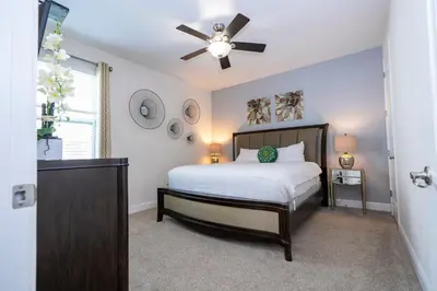 a bedroom with a bed and a ceiling fan at 510 BS - 5BD Cozy Family Haven with Pool in Orlando