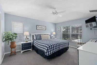 a bedroom with a bed with a checkered bedspread at Private Pool Close to Disney Lg Hm Slps 8 in Kissimmee