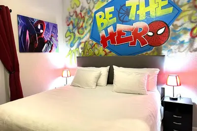 a bedroom with a bed with a superhero sign above it at Spider-Man-themed condo near Disney, Sea World, Universal and OCCC with pool, spa, restaurants, shuttle, private balcony, and view of fireworks shows in Orlando