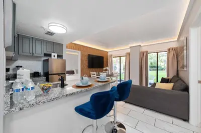 a kitchen and living room with a couch and a table at 2 suites ground floor apartment near Intern Drive in Orlando