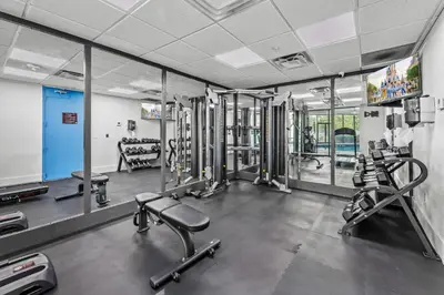 a gym with several treadmills and machines at 2 suites ground floor apartment near Intern Drive in Orlando