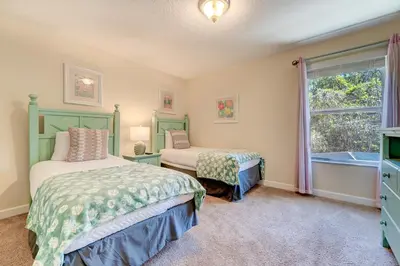 a bedroom with two beds and a window at Spacious 6BR family villa, 10 min to Disney, private pool, resort waterpark in Kissimmee