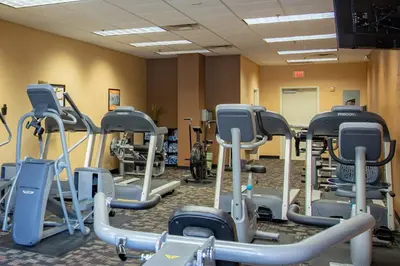 a gym with rows of treadmills and machines at Lion King-themed condo near Disney, Sea World, Universal and OCCC with pool, spa, restaurants, shuttle, private balcony, and the BEST view of fireworks shows in Orlando
